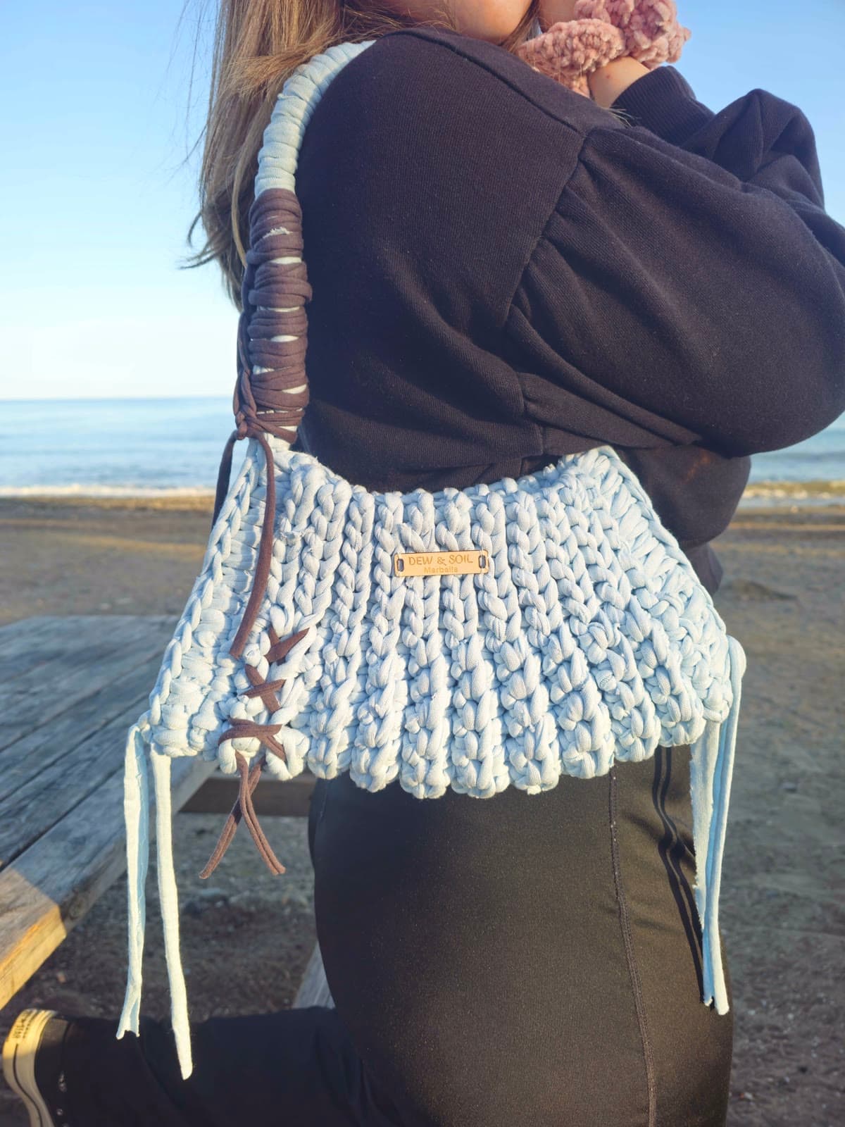 Sky Blue Crochet Tote — on weathered wood, tassels and leather side lacing detail